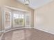 Bright living room with wood floors and shuttered windows allowing lots of natural light at 10500 E Mission Ln, Scottsdale, AZ 85258