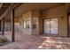 Covered patio features brick flooring, offering a comfortable outdoor living space at 10500 E Mission Ln, Scottsdale, AZ 85258