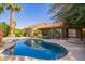 Sparkling backyard pool with a meticulously landscaped yard and mature palm trees at 10500 E Mission Ln, Scottsdale, AZ 85258