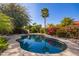 Refreshing pool surrounded by desert flora and mature trees, perfect for summer enjoyment at 10500 E Mission Ln, Scottsdale, AZ 85258