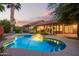 Inviting pool with a captivating sunset backdrop, perfect for relaxation and entertaining at 10500 E Mission Ln, Scottsdale, AZ 85258