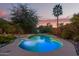 Private pool surrounded by mature landscaping creates a serene outdoor oasis at 10500 E Mission Ln, Scottsdale, AZ 85258