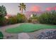 Private putting green surrounded by desert landscaping, perfect for golf enthusiasts at 10500 E Mission Ln, Scottsdale, AZ 85258