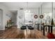 Bright dining room with a glass table, silver chairs, wood floors, and a view into the kitchen at 11515 N 91St St # 153, Scottsdale, AZ 85260