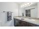 Bathroom featuring double sink vanity with granite countertop and tiled shower at 1201 E Gemini Dr, Tempe, AZ 85283