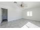 Minimalist bedroom features a ceiling fan, neutral walls, and a window for natural light at 1201 E Gemini Dr, Tempe, AZ 85283