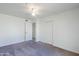 Bedroom with light walls, a ceiling fan, closet and attached bathroom with tile flooring at 1201 E Gemini Dr, Tempe, AZ 85283