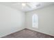 Clean and bright bedroom with neutral carpet, arched window and ceiling fan at 1201 E Gemini Dr, Tempe, AZ 85283