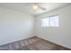 Bedroom featuring neutral walls, a ceiling fan, carpet, and a large window for lots of natural light at 1201 E Gemini Dr, Tempe, AZ 85283