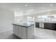 Modern kitchen featuring a center island, stainless steel appliances, and views of the outdoor pool at 1201 E Gemini Dr, Tempe, AZ 85283