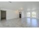 Spacious, light-filled living room with tile floors, arched windows and a modern neutral color palette at 1201 E Gemini Dr, Tempe, AZ 85283