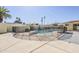 Backyard pool area with a diving board surrounded by a mesh fence at 1201 E Gemini Dr, Tempe, AZ 85283