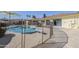Backyard pool with diving board, safety fence, patio, and umbrella shaded seating area at 1201 E Gemini Dr, Tempe, AZ 85283