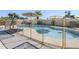 Backyard pool with a security fence, offering clear water and sunny skies at 1201 E Gemini Dr, Tempe, AZ 85283