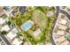 Aerial shot focuses on a community park featuring a basketball court, volleyball court, and playground at 1235 W Jeanine Dr, Tempe, AZ 85284