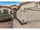 Close up exterior view of a home with an ADT security system and desert landscaping at 1235 W Jeanine Dr, Tempe, AZ 85284