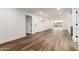 Spacious living room showing wood-look floors and two exterior doors with a view of the pool at 1326 E Catalina Dr, Phoenix, AZ 85014