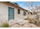 Small backyard patio area with mature landscaping, a privacy fence, and stucco home exterior at 137 N Robson St # 2, Mesa, AZ 85201