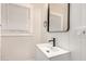 Bright bathroom featuring a modern vanity with a white sink, black faucet and minimalist mirror at 137 N Robson St # 2, Mesa, AZ 85201