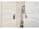 A stacked washer and dryer unit with a utility door and hot water tank in the background at 137 N Robson St # 2, Mesa, AZ 85201