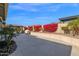 Landscaped backyard featuring lush greenery and a covered patio at 13734 W Harvest Ave, Litchfield Park, AZ 85340
