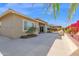 Exterior view of a well-maintained backyard with lush greenery and a covered patio at 13734 W Harvest Ave, Litchfield Park, AZ 85340