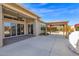 Home with sliding glass doors leads to a patio with a pergola, offering seamless indoor-outdoor living at 13734 W Harvest Ave, Litchfield Park, AZ 85340