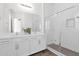 Modern bathroom featuring double sinks, stylish cabinets, and glass shower doors, highlighting its elegance and functionality at 13734 W Harvest Ave, Litchfield Park, AZ 85340