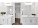 Bright bathroom featuring double vanity and access to walk-in closet at 13734 W Harvest Ave, Litchfield Park, AZ 85340