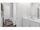 Bright bathroom featuring a white vanity, tub and shower combination, and decorative rug at 13734 W Harvest Ave, Litchfield Park, AZ 85340