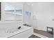 Bright bathroom featuring tub, walk-in shower, and tile flooring at 13734 W Harvest Ave, Litchfield Park, AZ 85340