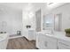 Bright bathroom featuring double vanity, walk-in shower, and tile flooring at 13734 W Harvest Ave, Litchfield Park, AZ 85340