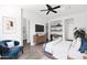 Stylish bedroom featuring hardwood floors, a ceiling fan, and built in shelving in neutral tones at 13734 W Harvest Ave, Litchfield Park, AZ 85340
