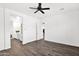 Spacious bedroom showcasing wood-look floors and ensuite bath at 13734 W Harvest Ave, Litchfield Park, AZ 85340