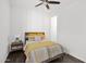 Bright bedroom featuring a ceiling fan, wood floors, and neutral decor at 13734 W Harvest Ave, Litchfield Park, AZ 85340