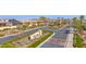 Aerial view of the community entrance showcasing lush landscaping, mature trees, and architectural details at 13734 W Harvest Ave, Litchfield Park, AZ 85340