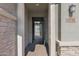 View of the front entrance showing a secure metal gate leading to a brick-paved pathway at 13734 W Harvest Ave, Litchfield Park, AZ 85340