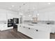 Spacious kitchen features white cabinets, a large island, and modern appliances at 13734 W Harvest Ave, Litchfield Park, AZ 85340