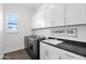 Laundry room featuring modern appliances and ample counter space at 13734 W Harvest Ave, Litchfield Park, AZ 85340