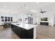 Open concept living room with a large island and sliding glass doors at 13734 W Harvest Ave, Litchfield Park, AZ 85340