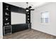 Modern living room featuring a built-in entertainment center and a wine fridge for entertaining at 13734 W Harvest Ave, Litchfield Park, AZ 85340