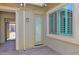 Mud room featuring convenient cabinet storage, mini refrigerator, and direct outdoor access at 13734 W Harvest Ave, Litchfield Park, AZ 85340