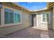 Cozy outdoor patio area with brick pavers, string lights, and neutral-toned walls for relaxing at 13734 W Harvest Ave, Litchfield Park, AZ 85340