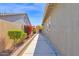 This side yard features decorative landscaping and lush greenery, providing privacy at 13734 W Harvest Ave, Litchfield Park, AZ 85340
