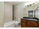 Bathroom with a tub-shower, dark vanity, and a large mirror at 1400 E Bethany Home Rd # 27, Phoenix, AZ 85014