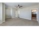 Spacious bedroom with neutral carpet, ceiling fan, and an ensuite bathroom at 1400 E Bethany Home Rd # 27, Phoenix, AZ 85014
