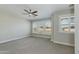Bright bedroom with carpet, ceiling fan and windows with white shutters at 1400 E Bethany Home Rd # 27, Phoenix, AZ 85014