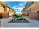 Landscaped courtyard between condo buildings, showing walking paths and blue sky at 1400 E Bethany Home Rd # 27, Phoenix, AZ 85014