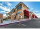 Contemporary condo building showing brick facade, stucco accents, and blooming bougainvillea at 1400 E Bethany Home Rd # 27, Phoenix, AZ 85014