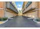 Multiple garage doors lined up on either side of a paved driveway at 1400 E Bethany Home Rd # 27, Phoenix, AZ 85014